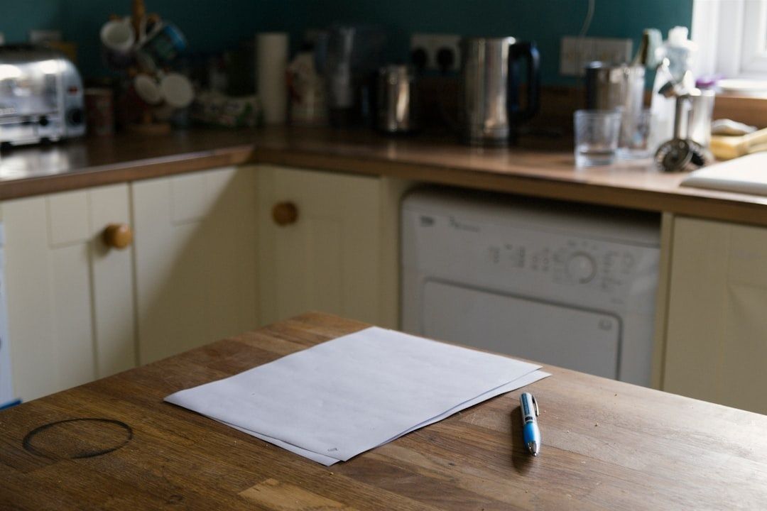 Blank papers and a pen on a kitchen table for care planning